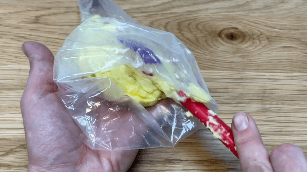 spoon leftover buttercream into piping bag 5 Cakes You Can Decorate in 5 Minutes