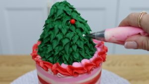 attach sprinkles with buttercream dots to decorate christmas tree 5 Christmas Cake Decorating Ideas