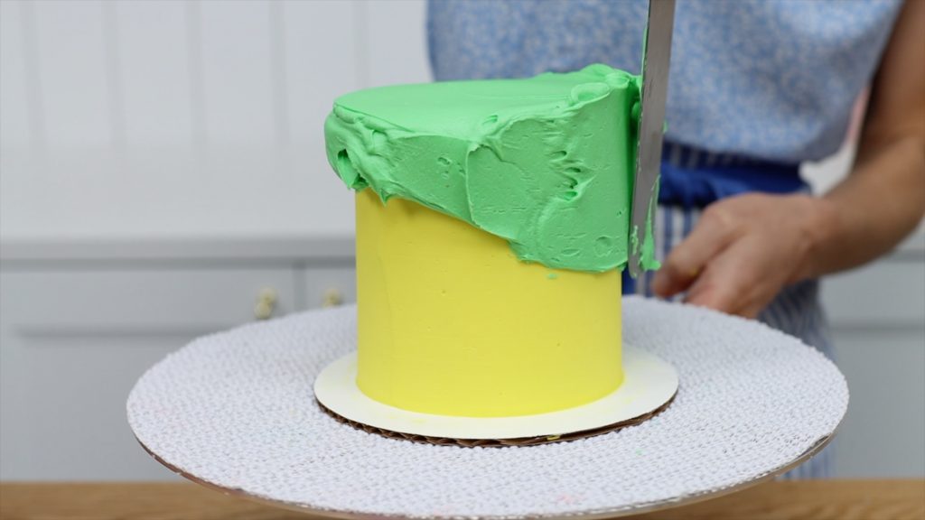 frost a cake with two layers of colour frosting for buttercream carving 5 Striped Cake Hacks