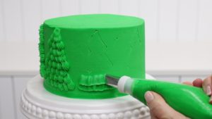 pipe a christmas tree onto a cake with a petal tip to make layered ruffles 5 Christmas Cake Decorating Ideas