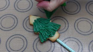 pipe buttercream onto cookies with piping bags or ziplock bags 5 Christmas Cake Decorating Ideas