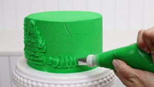 pipe petals onto a cake with a petal tip to make a christmas tree 5 Christmas Cake Decorating Ideas