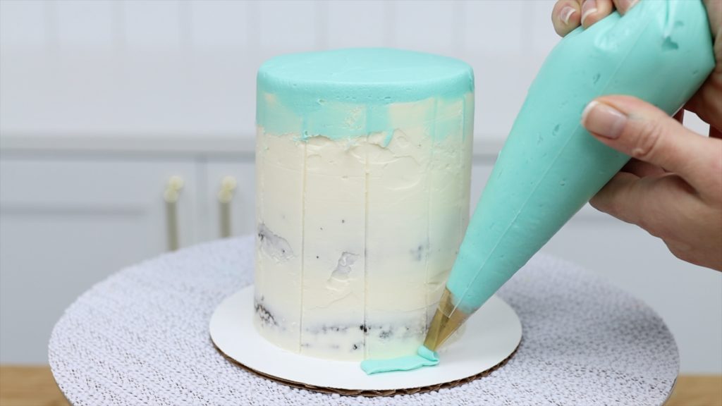 piping stripes onto cake using a petal tip 5 Striped Cake Hacks