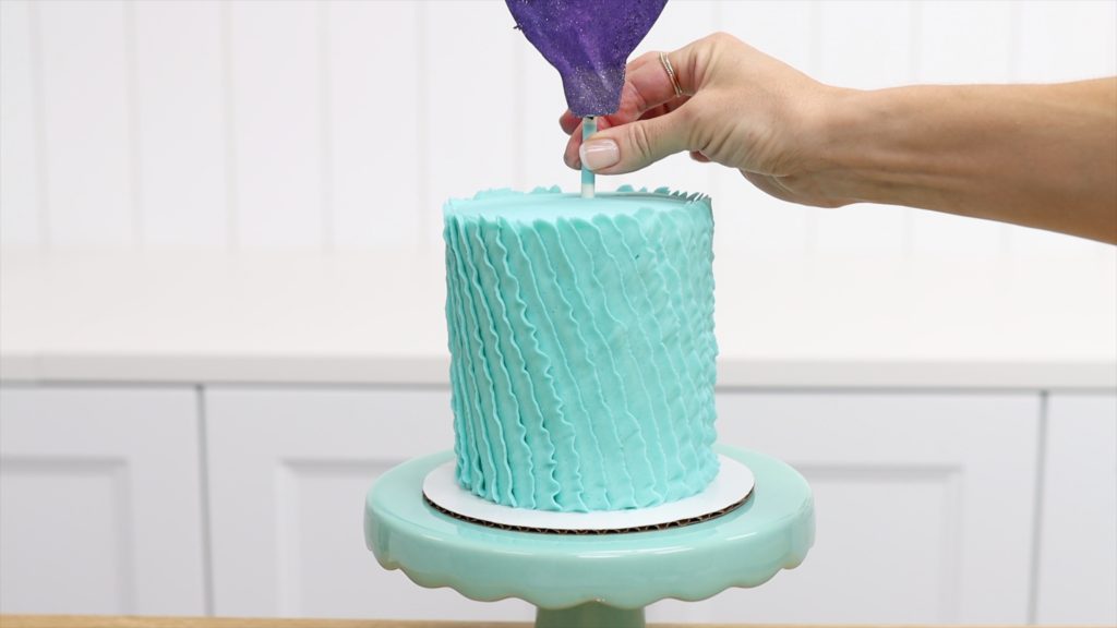 poke cake topper into cake on straw 4 Stunning Homemade Cake Toppers