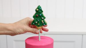 push cake topper on paper straw into cake 5 Christmas Cake Decorating Ideas