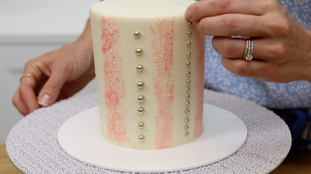 push sprinkles into frosted cake to make stripes 5 Striped Cake Hacks