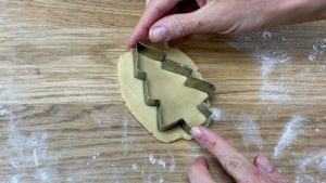 roll cookie cough and cut with cookie cutter to make a cake topper 5 Christmas Cake Decorating Ideas