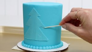 tidy up stencil outline with toothpick 5 Christmas Cake Decorating Ideas