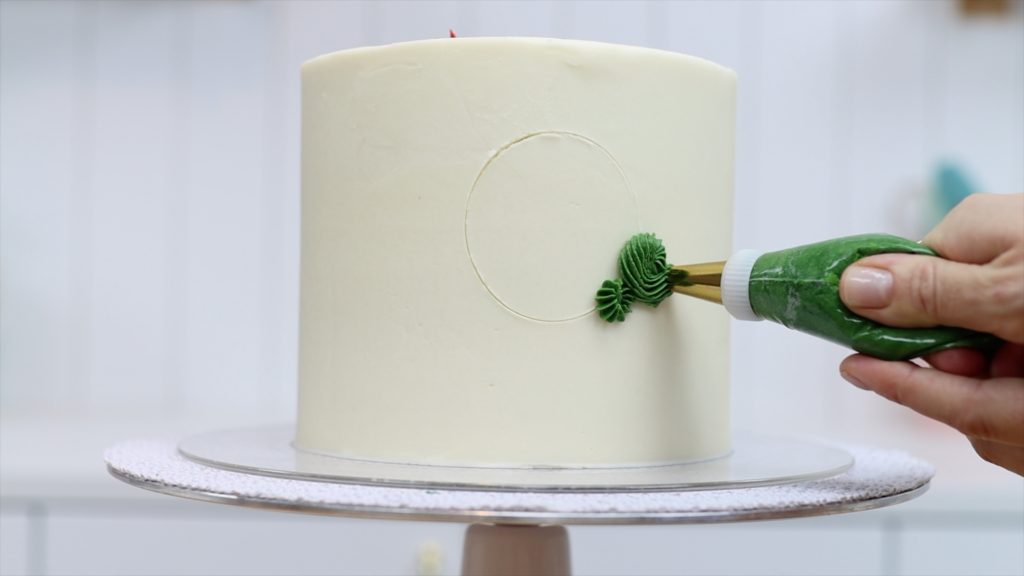 use a round cookie cutter to outline a wreath on a cake before piping 11 BAKERY SECRETS for Cake Decorating