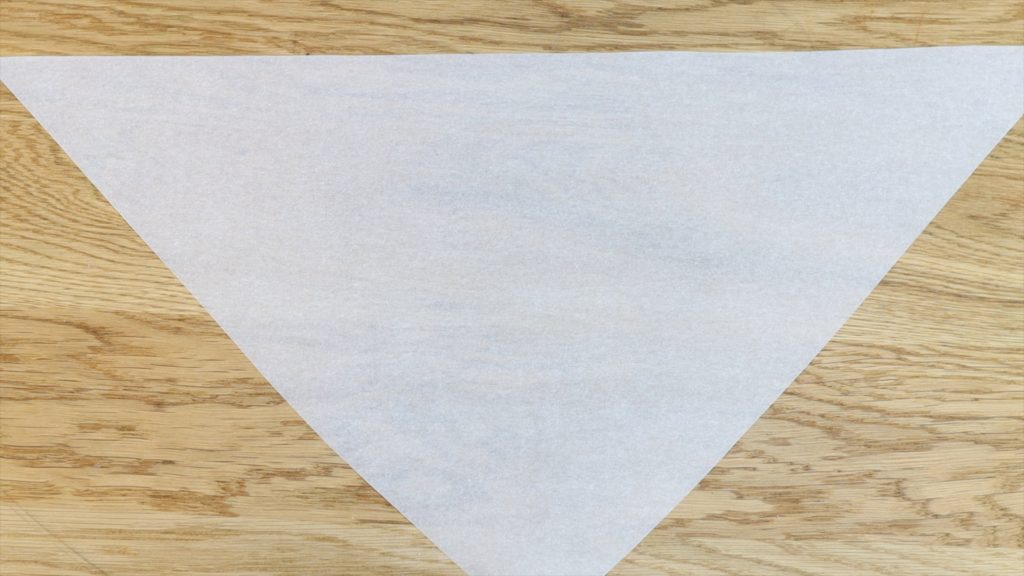 use a triangle of parchment paper to make a piping bag 11 BAKERY SECRETS for Cake Decorating