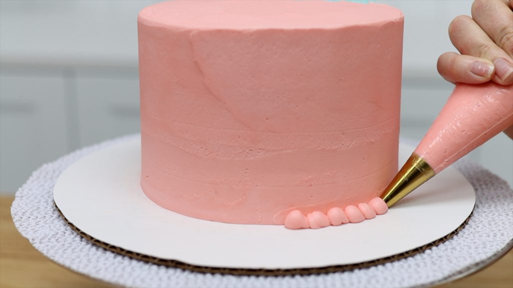 use leftover buttercream from frosting cake to pipe a border onto cake 11 BAKERY SECRETS for Cake Decorating