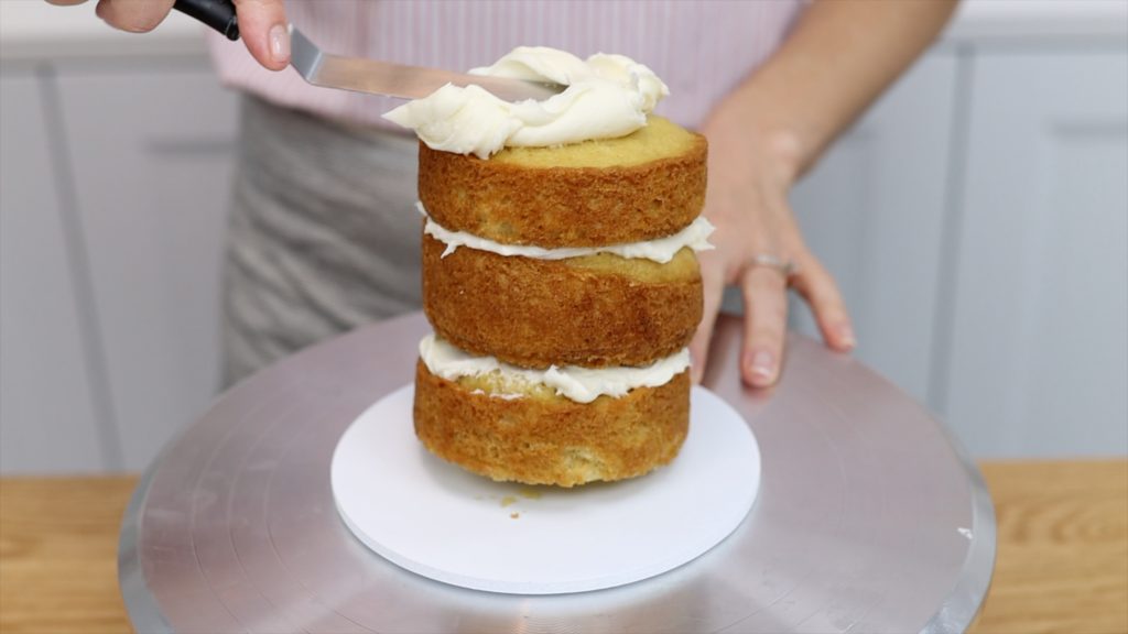 buttercream dot on cake board attaches cake so it doesn't wobble or fall over 15 Frosting Mistakes You're Making