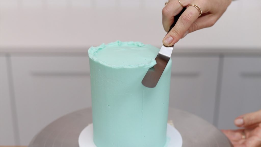 don't push down with your offset spatula when you tidy up the top edge of the cake because you'll create bulges in the frosting 15 Frosting Mistakes You're Making