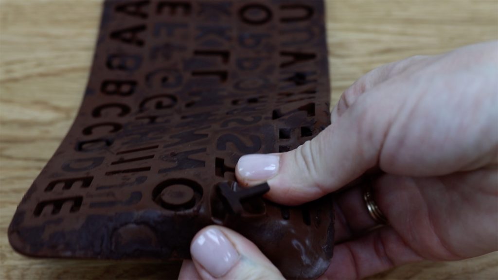 how to get chocolate letters out of silicon mold to write on cakes