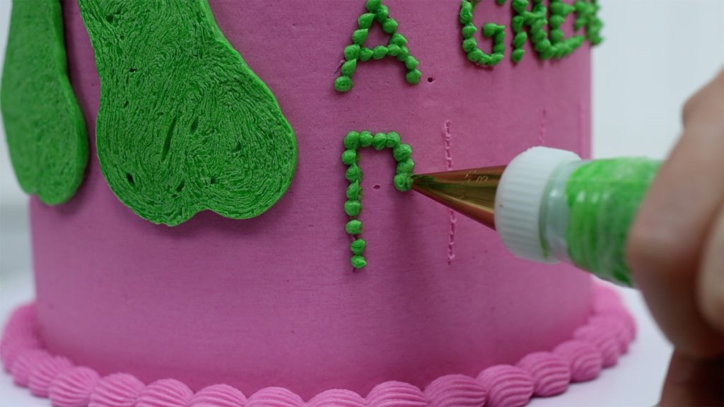 piping dots is the easiest way to write on the sides of cakes