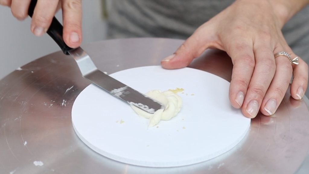 spread buttercream on cake board before assembling cake to hold it in place 15 Frosting Mistakes You're Making