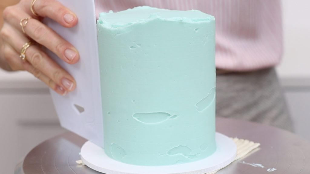 touch up indents by spreading more frosting over them and scrape the frosting with a cake comb to smooth it 15 Frosting Mistakes You're Making