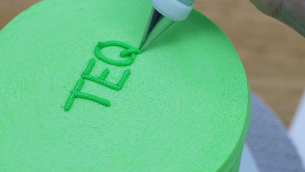 use a turntable for the easiest piping of letters onto a cake