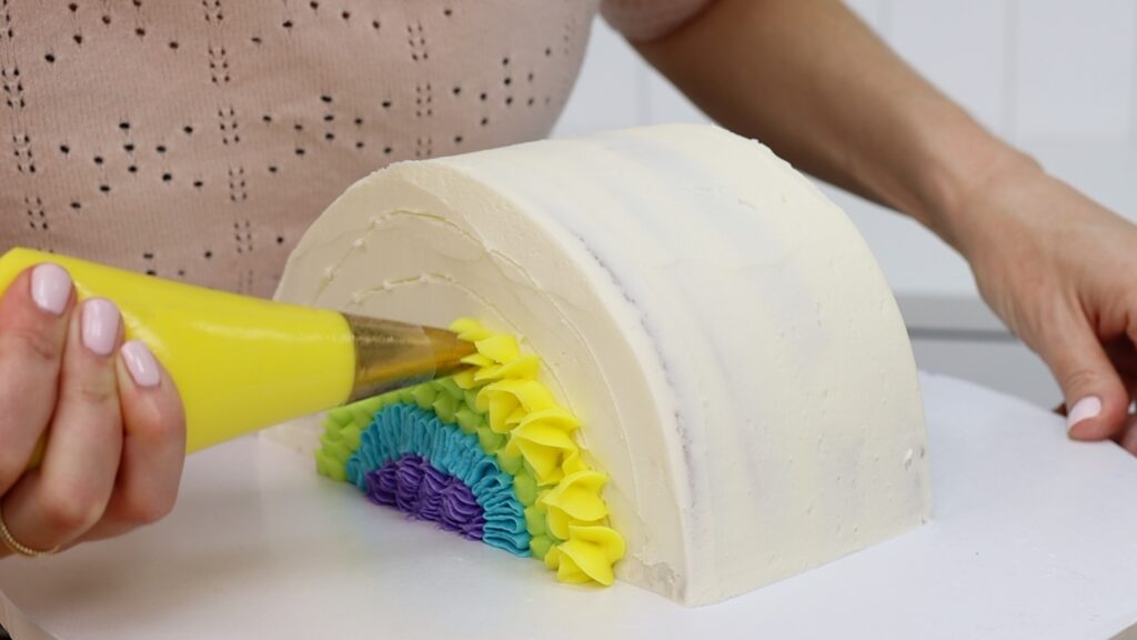 How To pipe Rainbow frosting on a rainbow Cake | British Girl Bakes