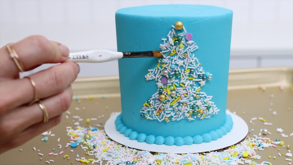 https://www.britishgirlbakes.com/wp-content/uploads/2022/02/how-to-make-shapes-with-sprinkles-on-cakes-Parchment-Paper-Cake-Hacks-1024x576.jpg