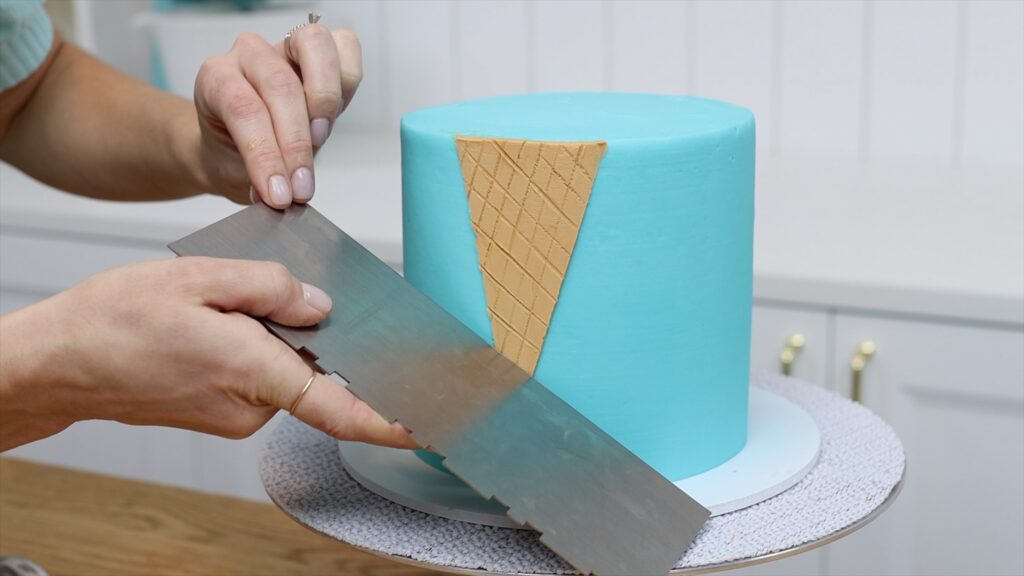 imprint waffle texture into ice cream cone using straight side of cake comb How to Make an Ice Cream Cake | British Girl Bakes