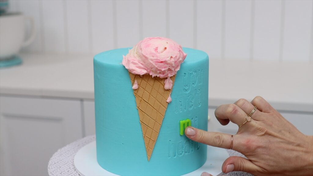 push sweet stamp letters into buttercream frosting after it sets How to Make an Ice Cream Cake | British Girl Bakes