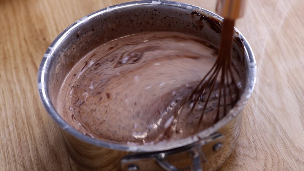 whisk cream and chocolate to make chocolate ganache for 4 desserts