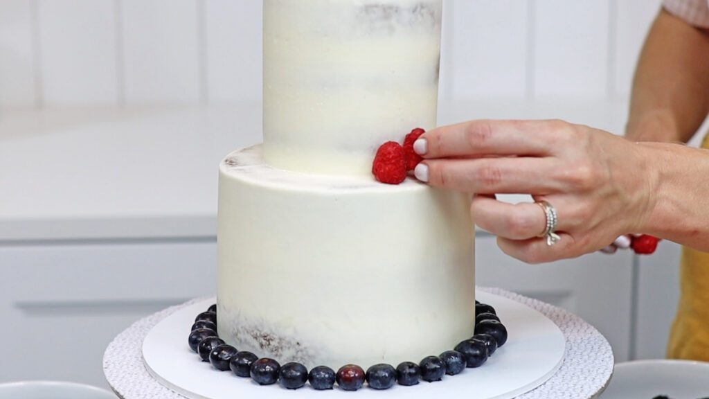 push berries into frosting on cake to make red white and blue cake decoration copy