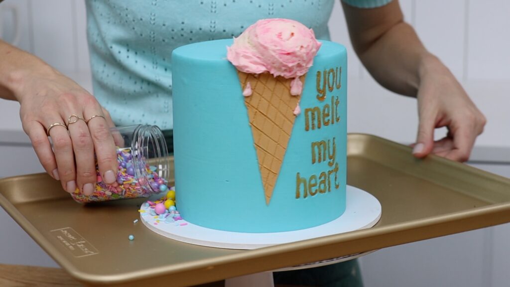 use baking tray as a secret tool to catch sprinkles during cake decorating