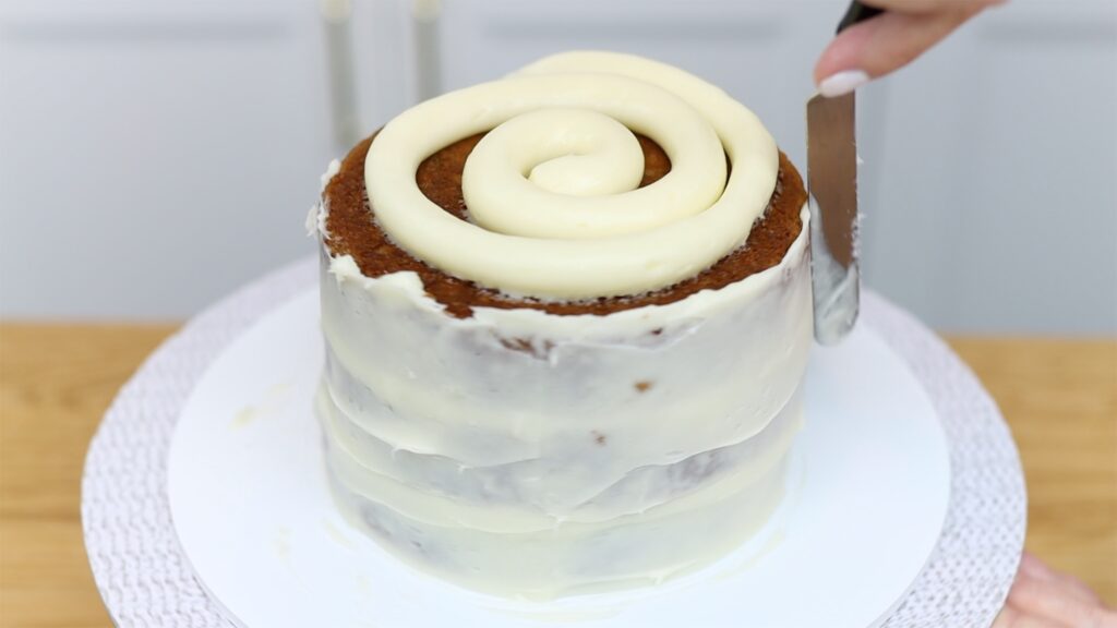 crumb coat of cream cheese frosting on banana cake