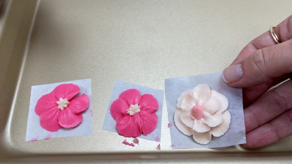 how to attach piped flowers to a cake