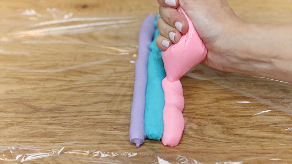 how to pipe rainbow frosting in saran wrap