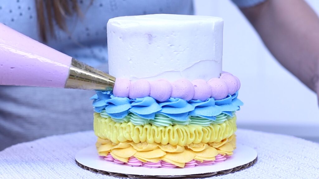 rainbow piping on cake with a round tip