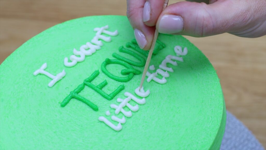 use a toothpick to fix messy lettering mistakes on cakes