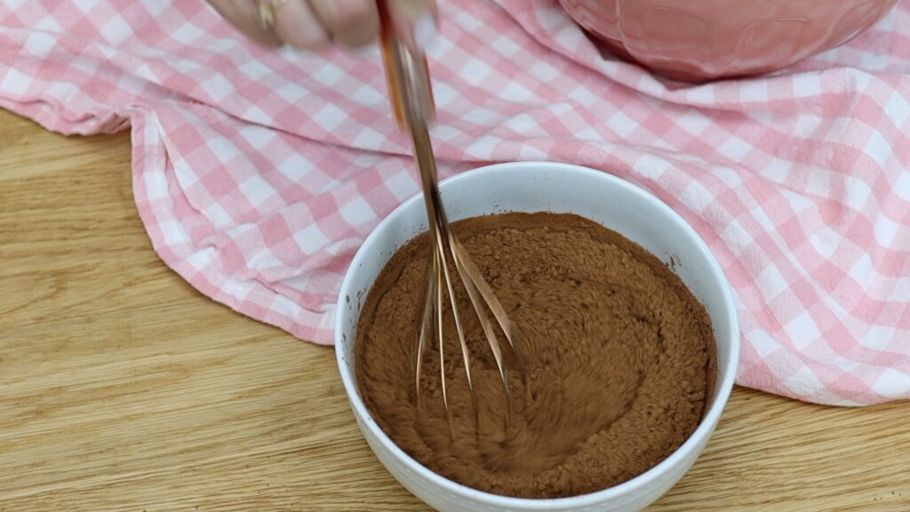 whisk cocoa powder and hot water together to make chocolate batter for easy marble cake