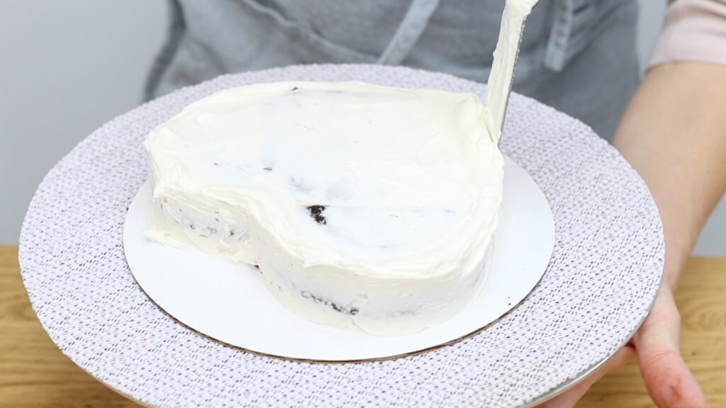 crumb coat frosting on heart cake