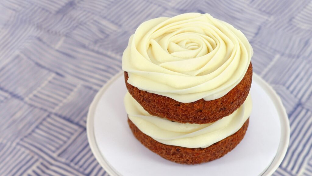 naked cake with piped cream cheese frosting