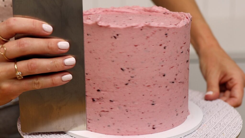 preparing frosting for a loaded cake