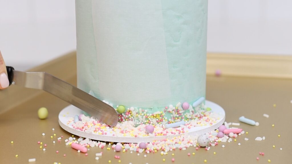 push sprinkles into the frosting on the cake