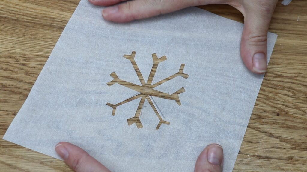 homemade snowflake stencil made with parchment paper