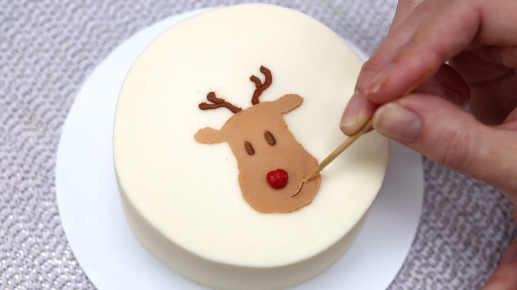 make a mouth on the reindeer with a toothpick