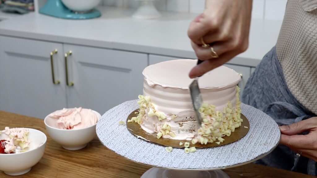 scrape decorations off grocery store cake for cake makeover