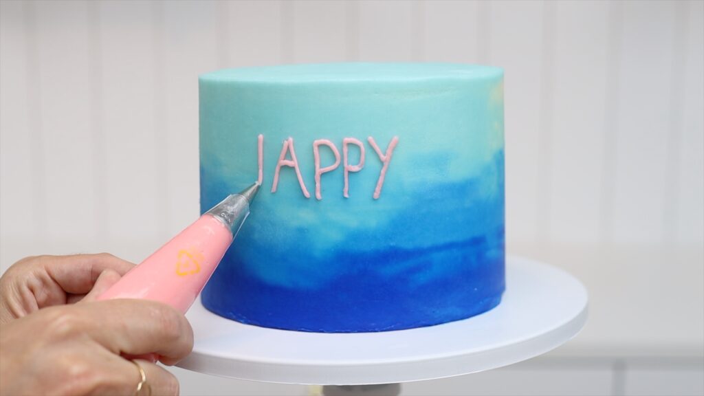 How to pipe Happy Birthday on Cakes with a round piping tip