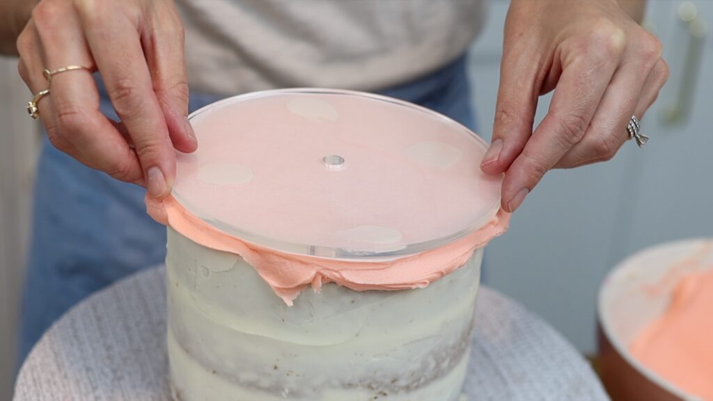 place an acrylic disc on top of the cake after frosting the top