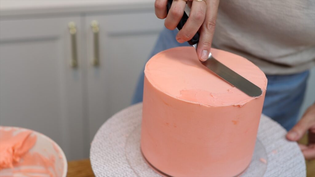 spread more frosting over air pockets on the top of the cake after taking off the acrylic disc