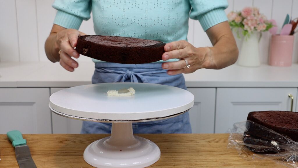 how to prevent the cake moving while you scrape the frozen piping off