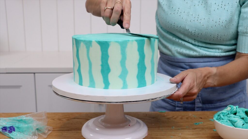 smooth the frosting on top of each cake