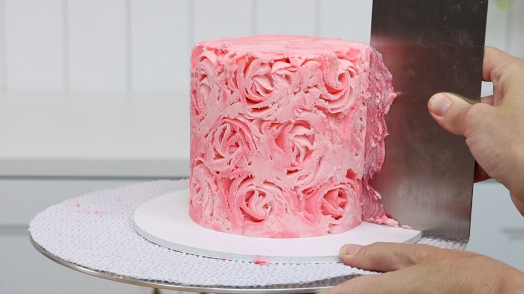 use a hot metal cake comb to scrape the frozen piping off the cake