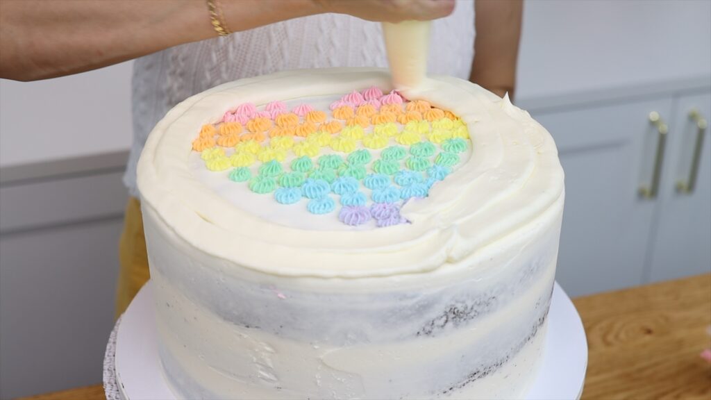 covering up piping for facelift frosting rainbow heart cake