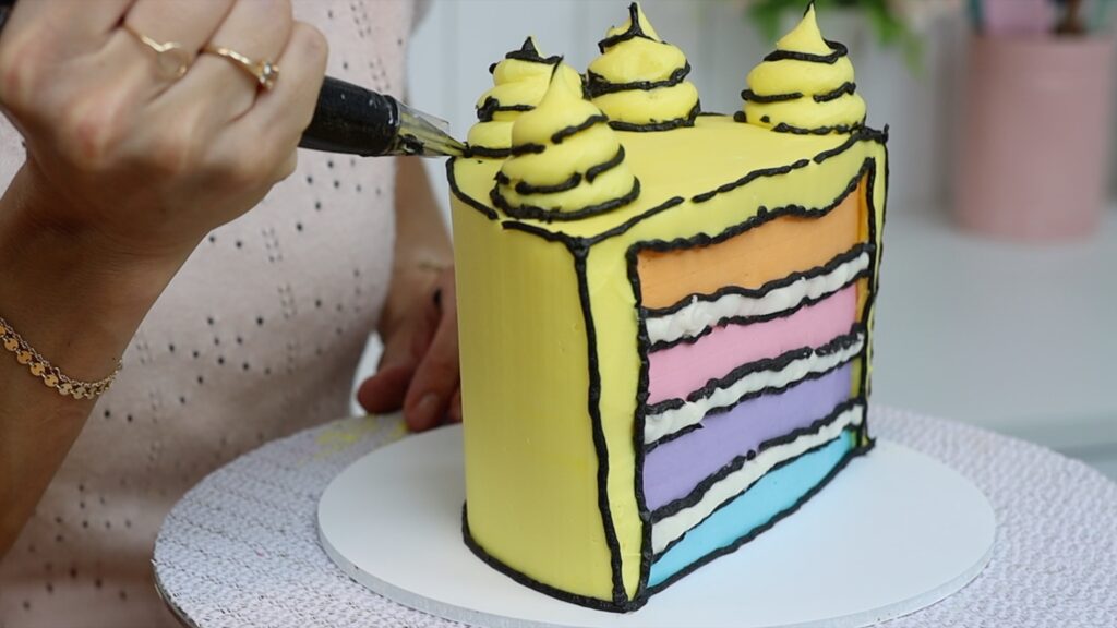 how to pipe black lines on a cartoon cake with buttercream